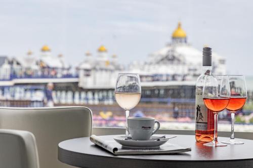a table with two glasses of wine and a bottle at The Burlington Hotel in Eastbourne