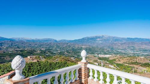 a balcony with a view of the mountains at Casa La Noria Iznate by Ruralidays in Iznate
