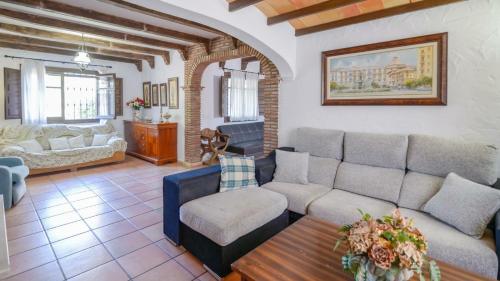a living room with a couch and a table at Cortijo Alejandro Malaga - Campanillas by Ruralidays in Málaga