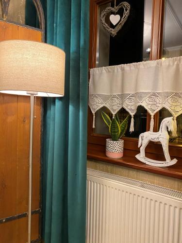 a window with a white curtain with a horse on it at Hotel i Restauracja Castle in Bystrzyca Kłodzka