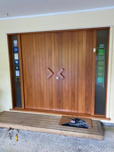 a cat is laying in front of a door at Bellrock Lodge in Russell