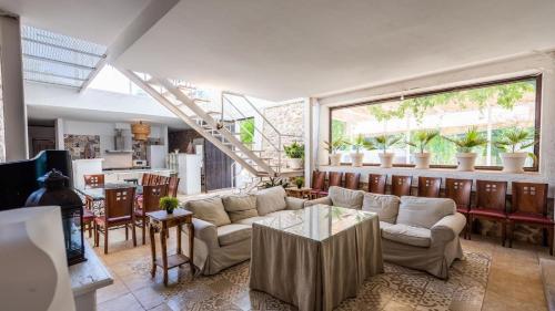 a living room with a couch and a table at Cortijo La Vega Archidona by Ruralidays in Archidona