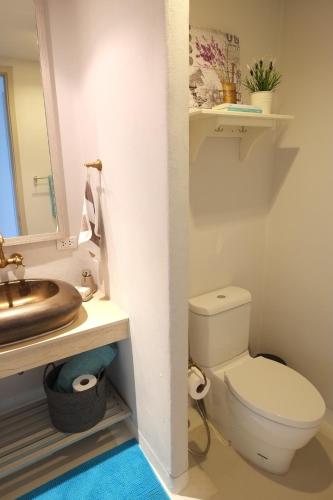 a bathroom with a toilet and a sink at Chelona 463 Khao Tao Condominium in Khao Tao