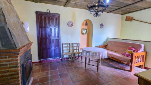 a living room with a couch and a table at Casa Rural Azahar Periana by Ruralidays in Periana