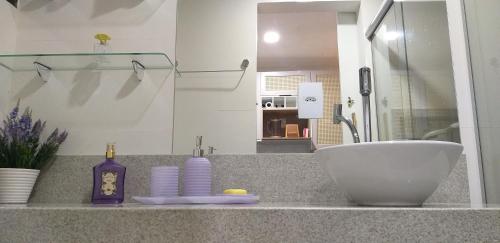 a bathroom counter with a sink and a bowl at Winterville Flat 905 in Gravatá