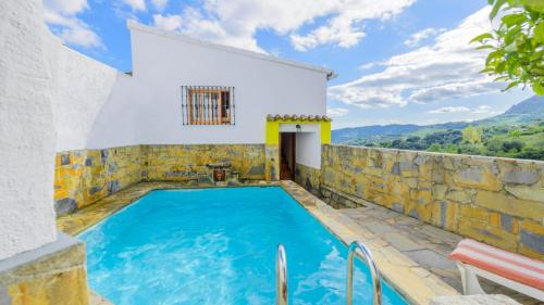 a villa with a swimming pool and a house at Casa El Limon Gaucin by Ruralidays in Gaucín