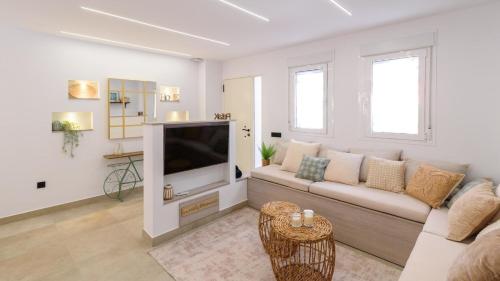 a living room with a couch and a tv at Maria's Head Villa Torre del Mar by Ruralidays in Torre del Mar
