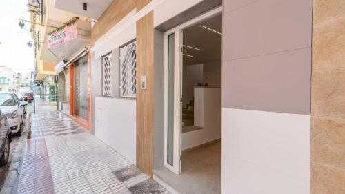 a building on a street with a sidewalk at Maria's Head Villa Torre del Mar by Ruralidays in Torre del Mar