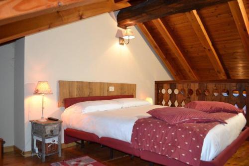 a bedroom with two beds in a room with wooden ceilings at maison terme relax in Pré-Saint-Didier