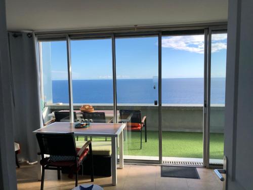 a room with a table and a view of the ocean at Viangella - Dramatic sea view! Top floor 2km to Monaco in Cap d'Ail