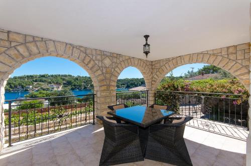 a patio with a table and a view of the water at Apartment Jakov in Rogač