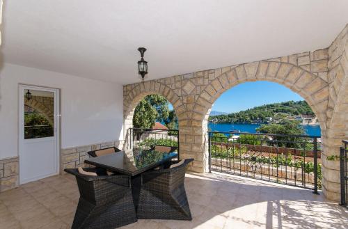 a room with a balcony with a view of the water at Apartment Jakov in Rogač