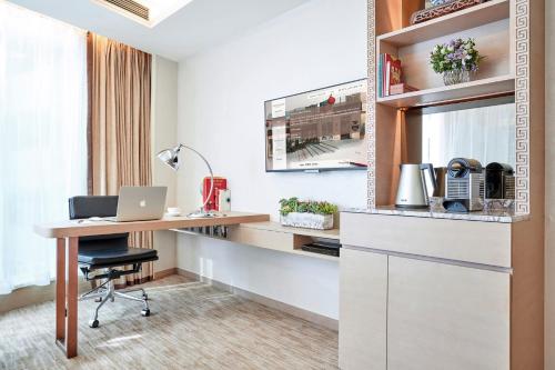 an office with a desk and a laptop on a table at The Pottinger Hong Kong in Hong Kong