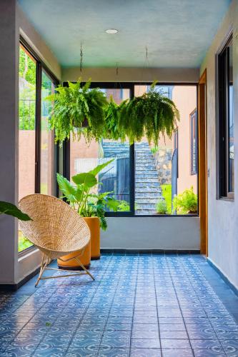 a room with a chair and a large window at Casa Lavanda Hotel Boutique in Pátzcuaro