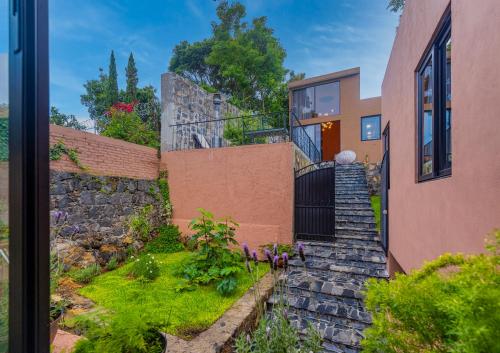 a house with a stone staircase leading up to a building at Casa Lavanda Hotel Boutique in Pátzcuaro