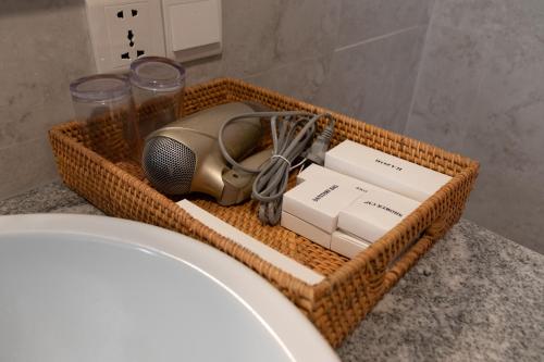 a wicker basket filled with items on a bathroom counter at Sayang Sanur Duplex in Sanur