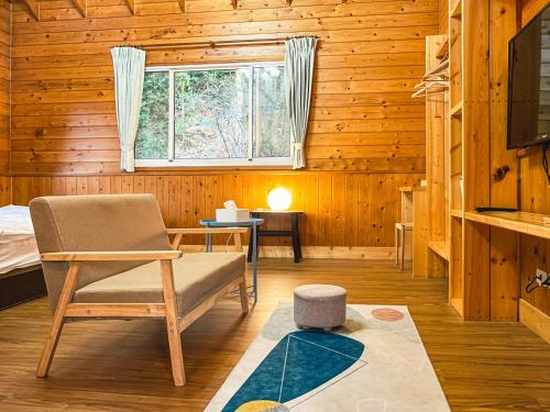 a living room with a couch and a window at Futen Villa in Sanyi
