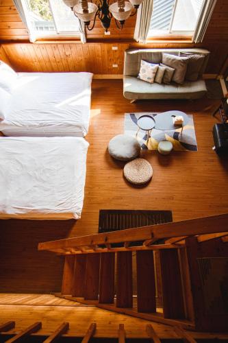 a room with two beds and a couch and a table at Futen Villa in Sanyi