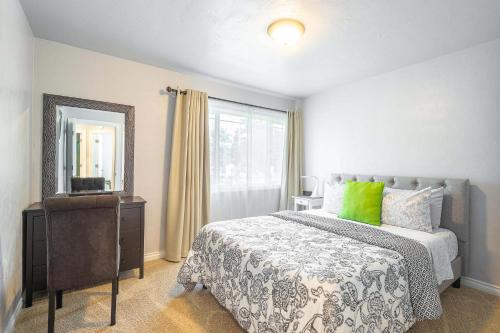 a bedroom with a bed with a dresser and a mirror at Duplex in Alberta Art District in Portland
