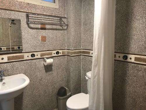 a bathroom with a sink and a toilet and a mirror at A-HOME in Jiufen