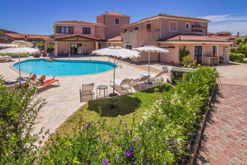 an image of a villa with a swimming pool at Hotel La Perla in Àrbatax