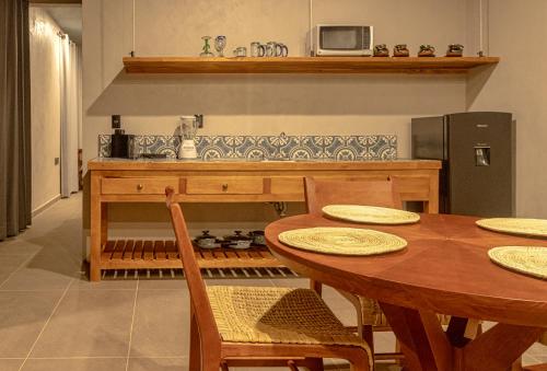 a kitchen with a wooden table with chairs and a stove at Casa Lavanda Hotel Boutique in Pátzcuaro