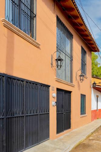 an orange building with black doors and windows at Casa Lavanda Hotel Boutique in Pátzcuaro