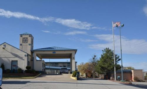 a building with a clock tower in a parking lot at OK Hotel in Oklahoma City