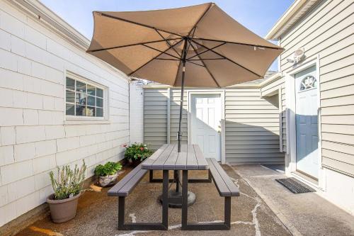a picnic table with an umbrella on a patio at Duplex in Alberta Art District in Portland
