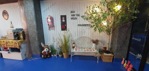 a toy room with a bed and some plants at Oedo Tour Pension in Geoje 