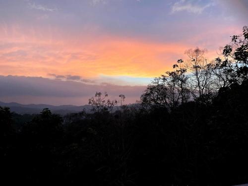a sunset with a rainbow in the sky at Elegant Hotel in Kandy