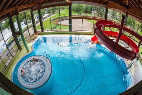 an overhead view of a pool with a water slide at Sanatorija ,,Tulpės" in Birštonas