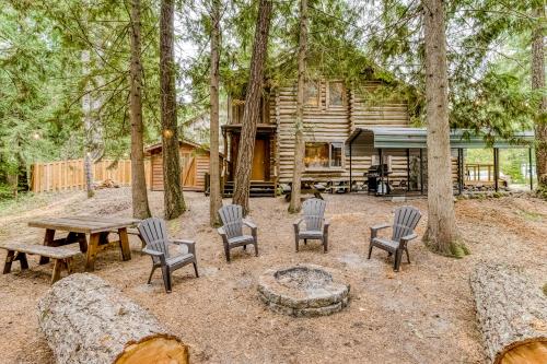 a cabin in the woods with a picnic table and chairs at Best Log Cabin in Brightwood
