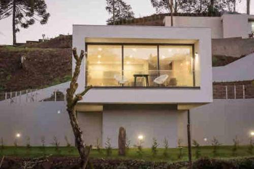 a house with a large window on the side of it at Viana do Castelo - Amonde Village - Casa L - Disfrute da Natureza in Amonde