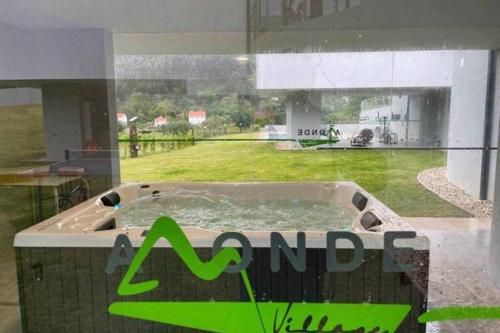 a jacuzzi tub in the middle of a building at Viana do Castelo - Amonde Village - Casa L - Disfrute da Natureza in Amonde