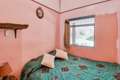 a bedroom with a bed and a window at Casita El Sastre in Paso Macho