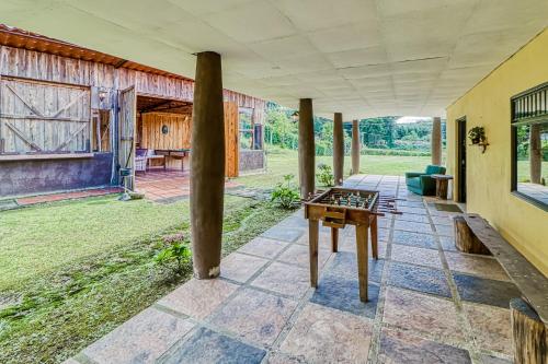 an outdoor patio with a table and a house at Casita El Sastre in Paso Macho