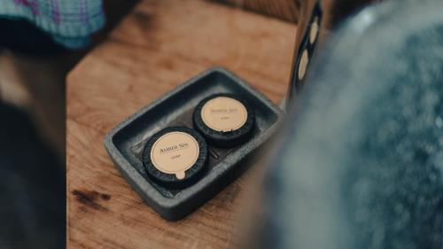 a remote control sitting on top of a wooden table at Alpensuite Wellness in Inzell