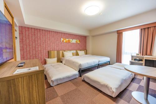 Ein Bett oder Betten in einem Zimmer der Unterkunft Tabino Hotel lit Matsumoto Milky white Onsen