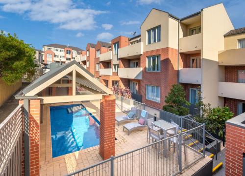 an apartment with a swimming pool on a balcony at MainStay Suites Kew in Melbourne