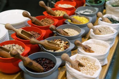 a table filled with bowls of different types of food at Park Hyatt Vienna in Vienna