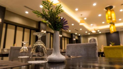 a table with two vases with flowers on it at LAOTEL VIENTIANE in Vientiane