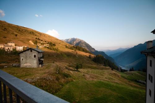 a view of a mountain with a house on a hill at Casa in un'esclusiva zona di Motta di Sotto in Motta