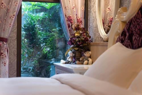 a bedroom with a bed and a window with teddy bears at 花蓮晨風星語民宿Sun Star B&B in Jian