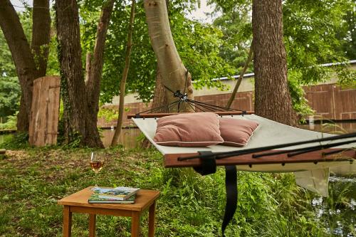 a hammock with two pillows and a glass of wine on a table at mein.lychen in Lychen