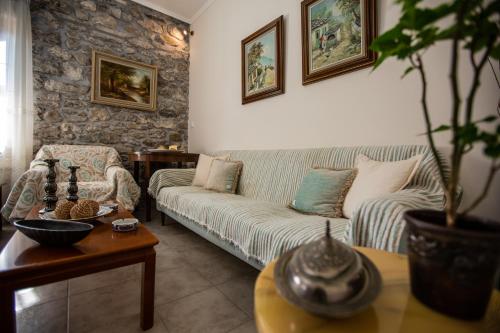 a living room with a couch and a table at Amaryllis Holiday Home in Agios Spiridon Fokidas