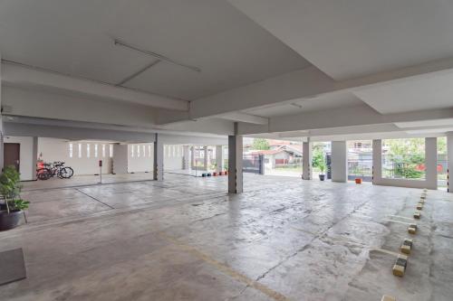 an empty building with a large empty room with windows at RedDoorz Syariah Plus near Tanjungpura University 2 Pontianak in Siantan