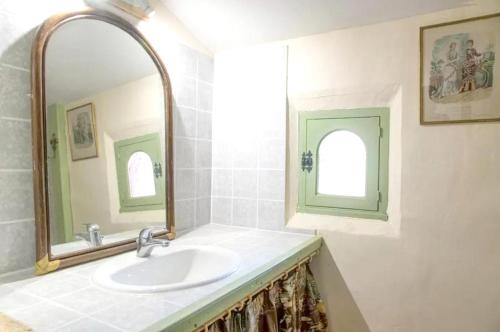 a bathroom with a sink and a mirror at Maison charmante à Landevieille avec jardin clos in Landevieille