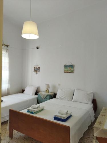 a bedroom with two beds with towels on them at Matina's agora apartment with Terrace in Leonidion