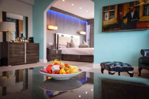 a bowl of fruit on a table in a room at Cumberland Hotel - OCEANA COLLECTION in Bournemouth